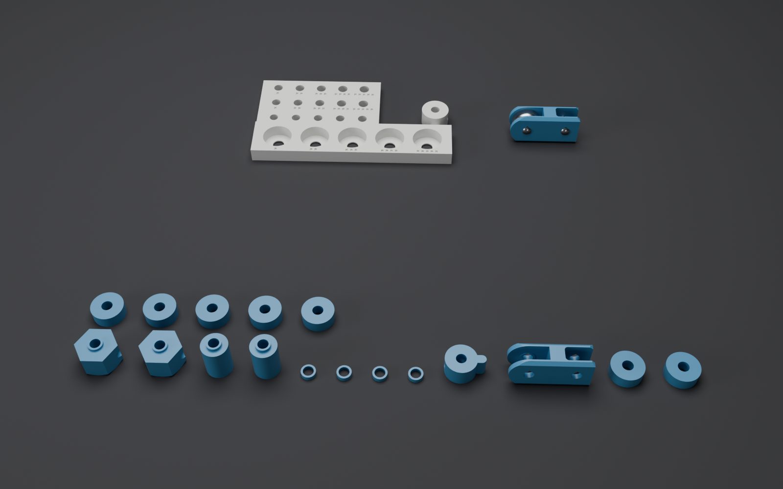 Small printed parts laid out: drive peg, shuttle, collars, spacers, sleeves.